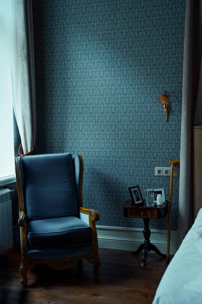 A cozy blue armchair in a tastefully decorated room with vintage elements.